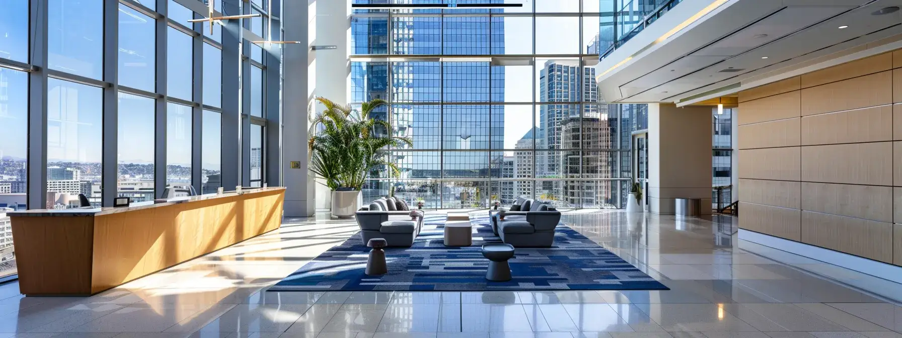 a sleek, modern office lobby with floor-to-ceiling windows overlooking the san diego skyline.